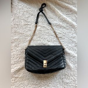 Black pleather gold trimmings crossbody purse.